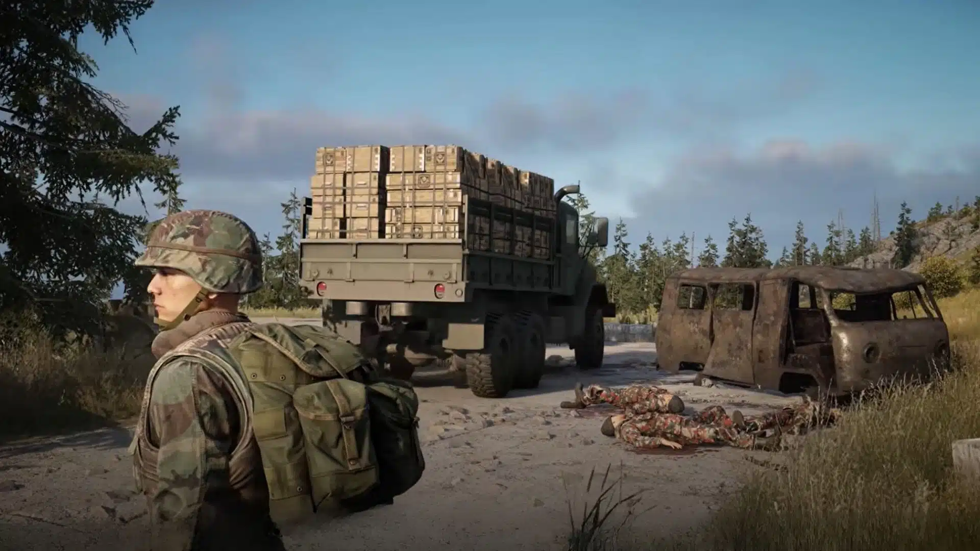 Soldier standing near military truck with supplies in a forested area