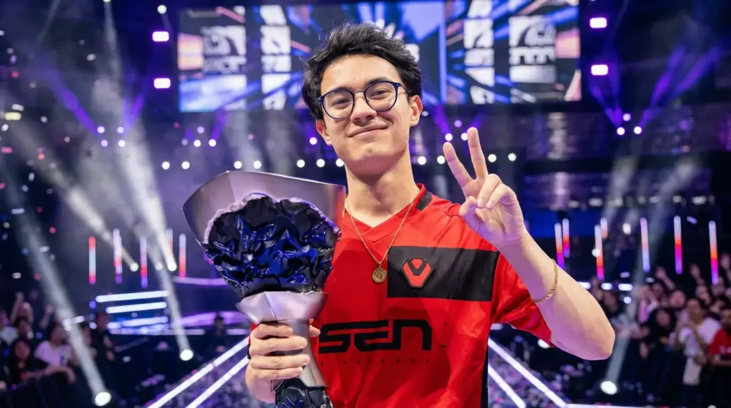 Zekken holding a trophy and celebrating on a stage with purple arena lights in the background