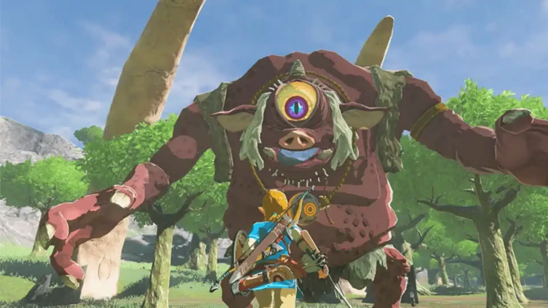 In-game scene from The Legend of Zelda: Breath of the Wild, showing Link facing a large one-eyed monster in a forested area with a bright open sky overhead.