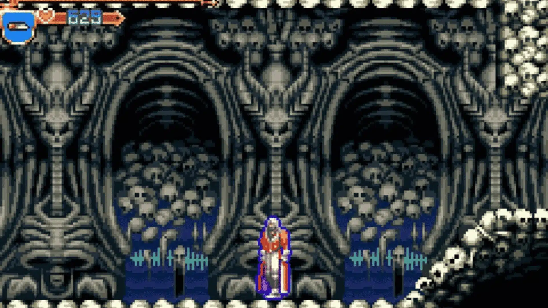 Castlevania: Aria of Sorrow gameplay showing Soma Cruz standing in a skull-covered, biomechanical dungeon room with 629 HP