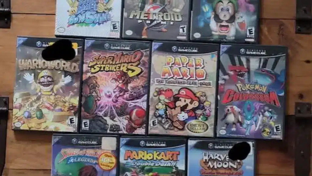 Collection of Nintendo GameCube game cases including Mario, Metroid, Luigi, Pokémon, and Mario Kart titles