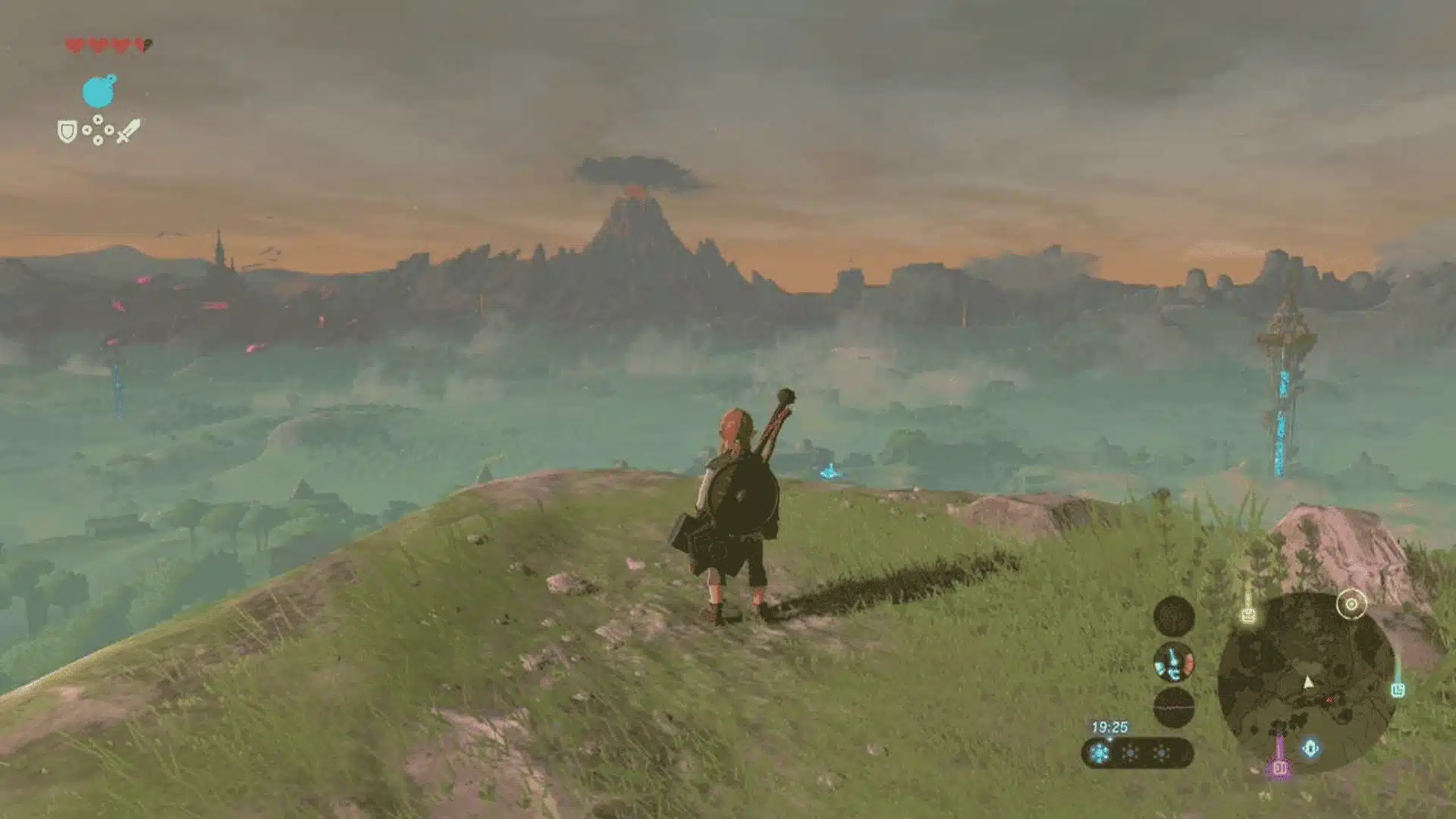 Link standing on a hilltop in Breath of the Wild, overlooking Hyrule's vast open world at dusk.