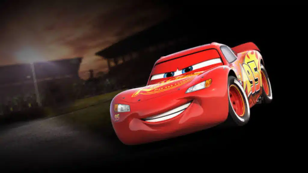Red racing car Lightning McQueen smiling as he speeds down a dark racetrack