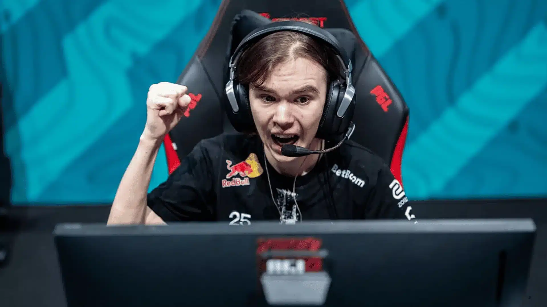 Gamer wearing headset at a PC setup during a competitive esports match