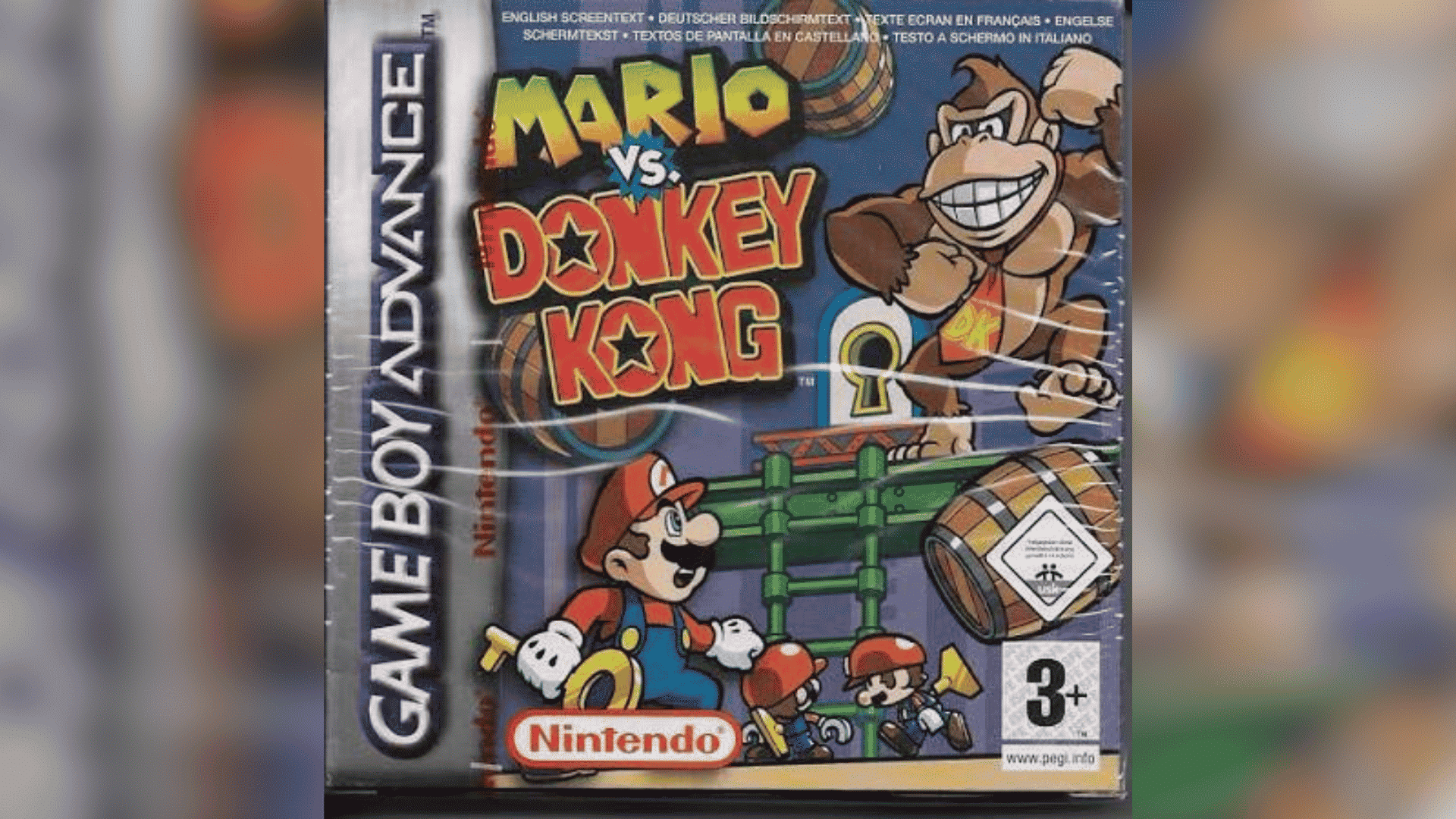 Mario vs. Donkey Kong gameplay showing Mario running through a toy city level with a key, locked door, and red block obstacles.