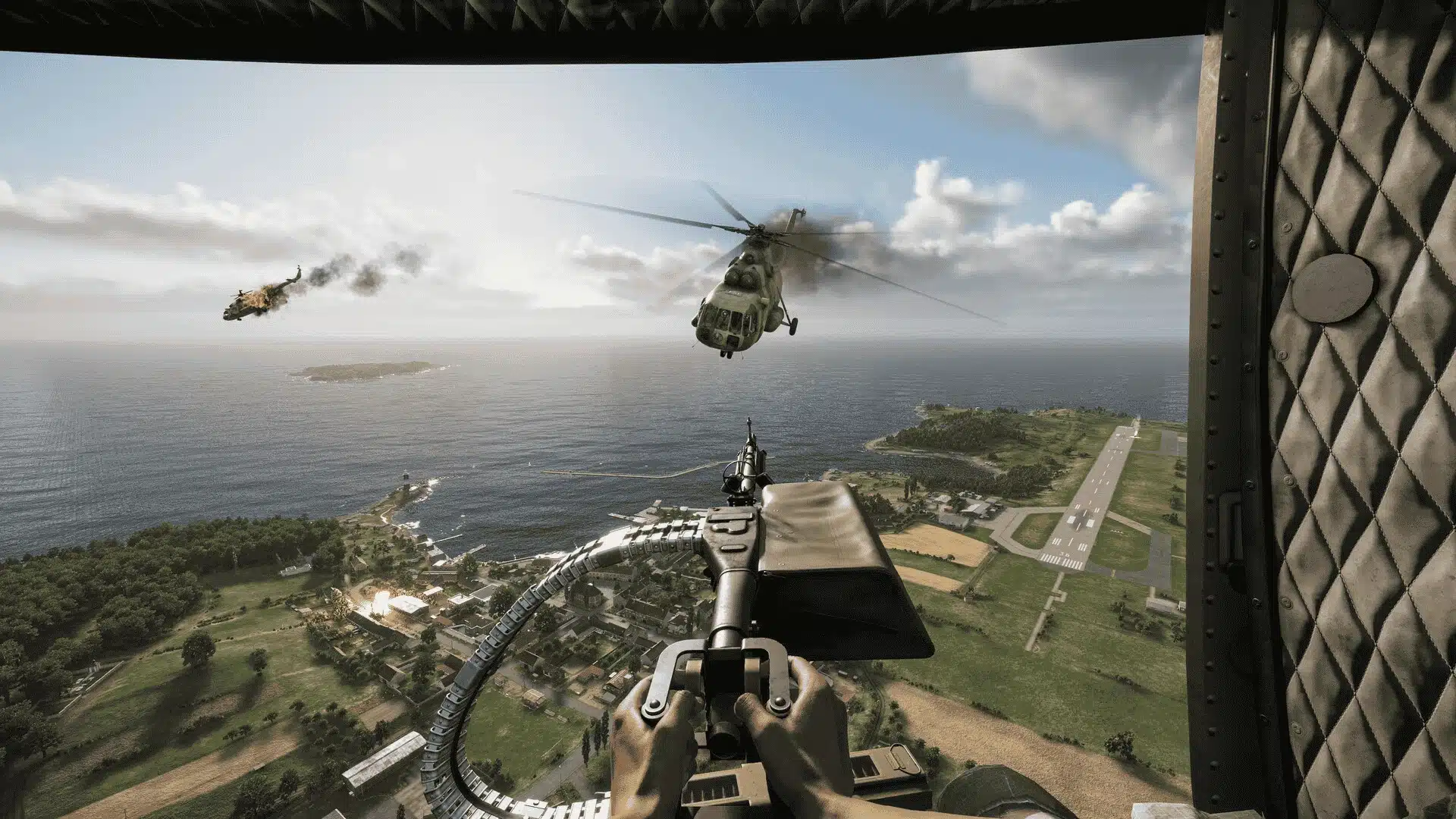 Helicopter gunner view flying above coastline with aircraft in formation