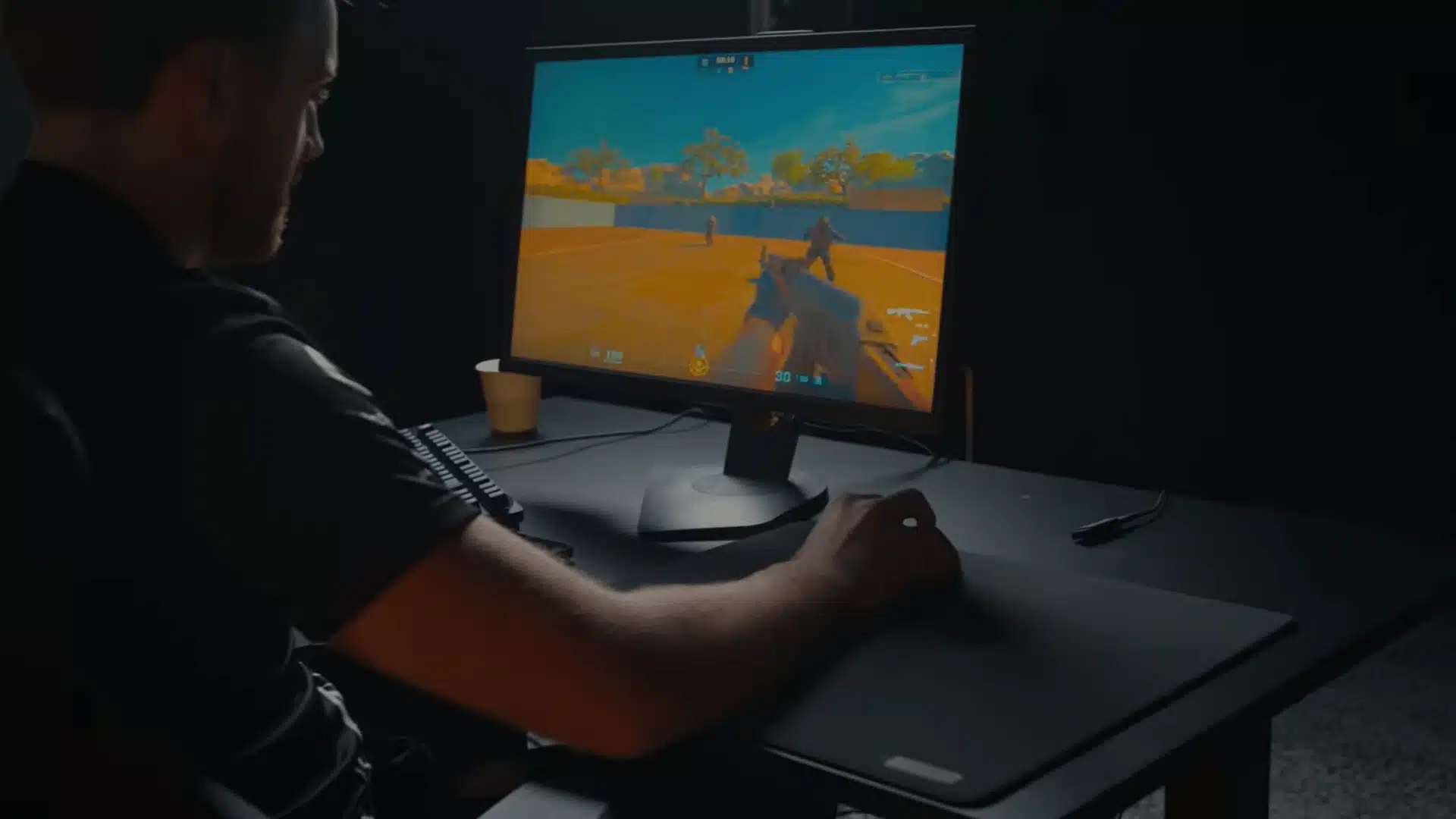 Player testing Counter-Strike gameplay on gaming monitor setup
