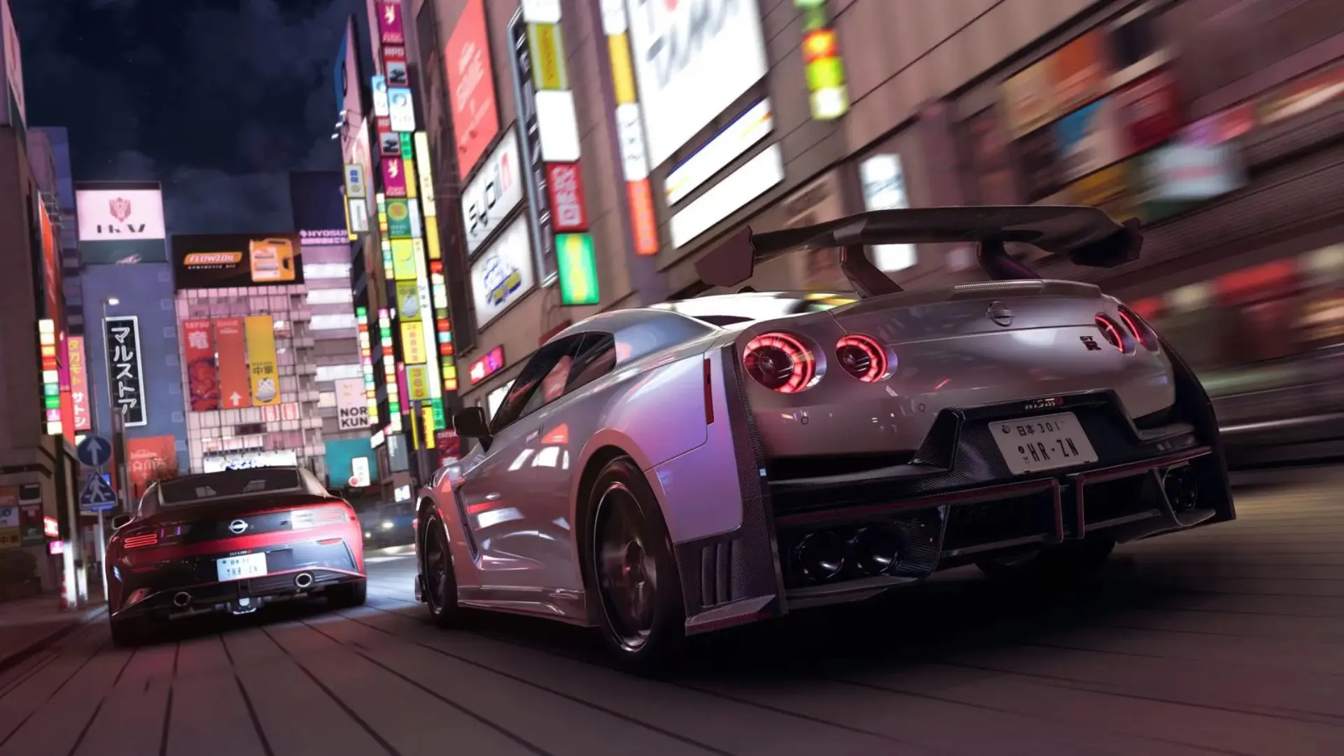 Forza Horizon 6 cars racing through a Japanese city street at night.