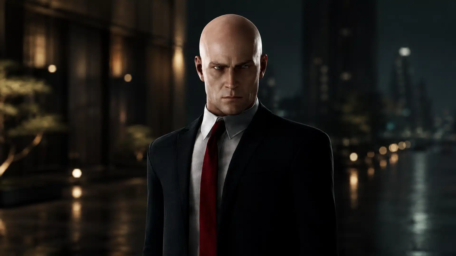 Agent 47 of Hitman: World of Assassination in a black suit stands before a dark, softly lit cityscape at night