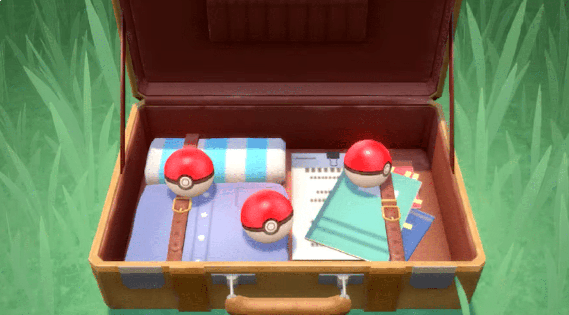 Open suitcase containing three Poké Balls, clothing, notebooks, and travel supplies in Pokémon Brilliant Diamond.