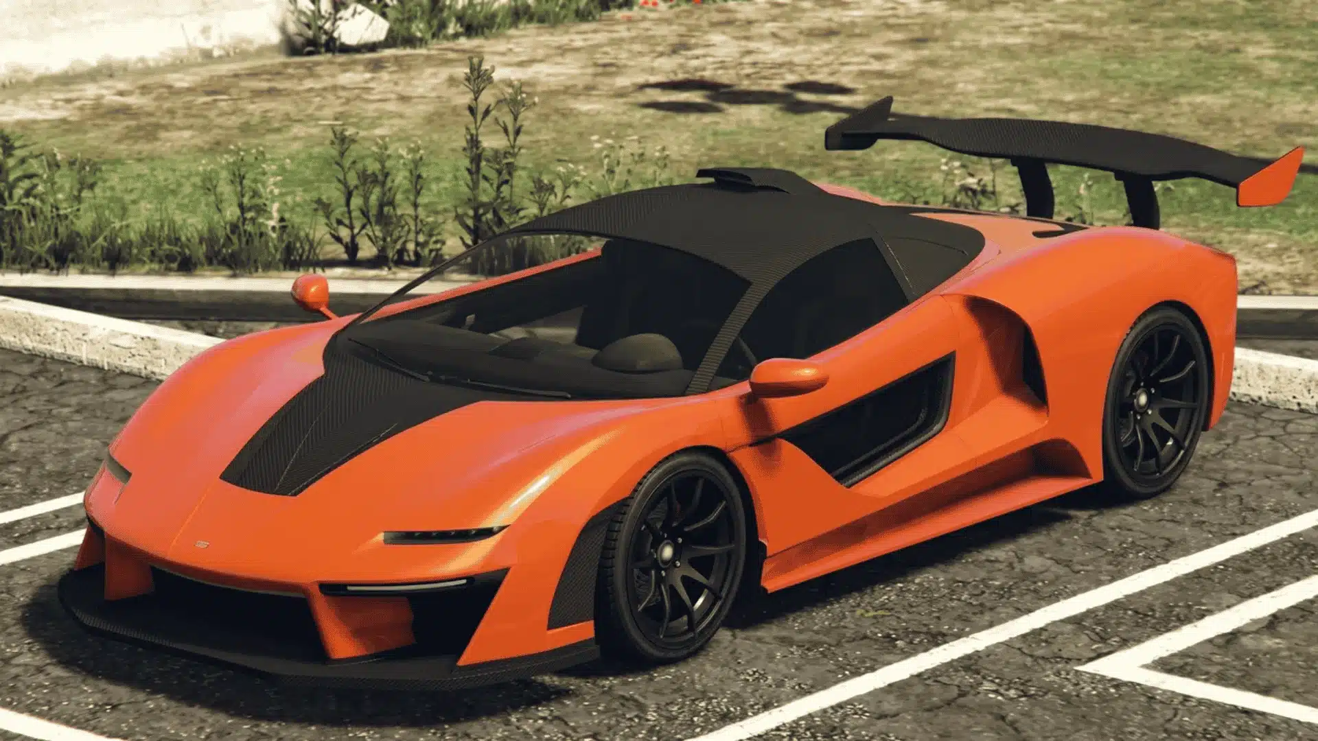 Orange Progen Emerus with black accents and a large rear wing parked in a GTA Online lot