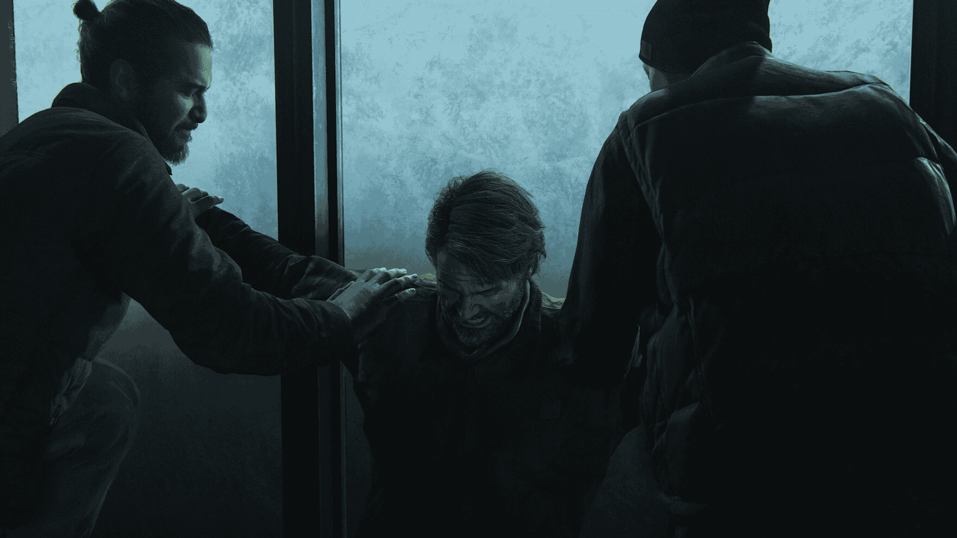 The Last of Us Part 2 scene showing Joel restrained by two people in a dark room