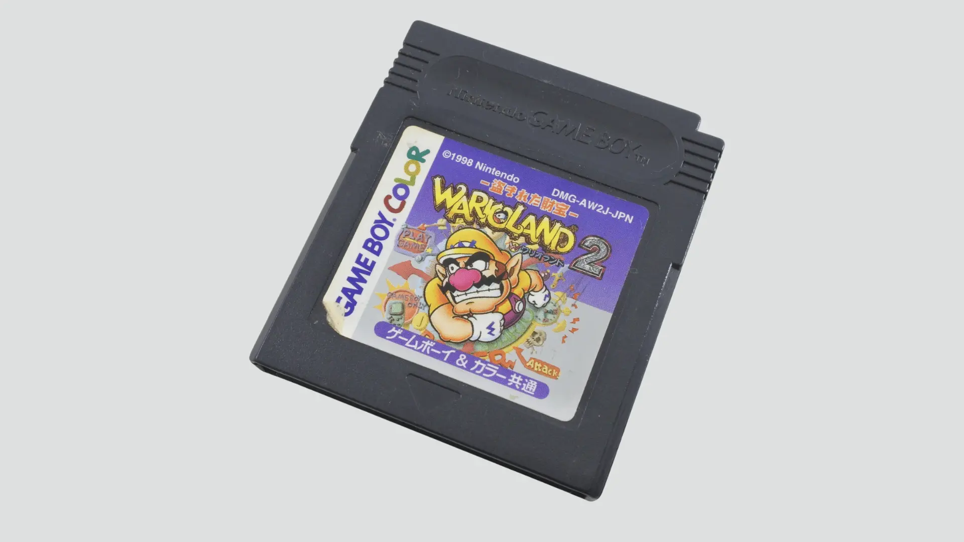 Game Boy Color Wario Land 2 cartridge angled on light gray background