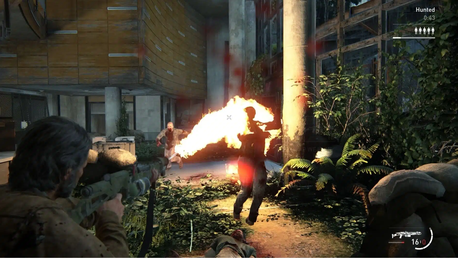 The Last of Us Part II gameplay showing a combat encounter with enemies and fire