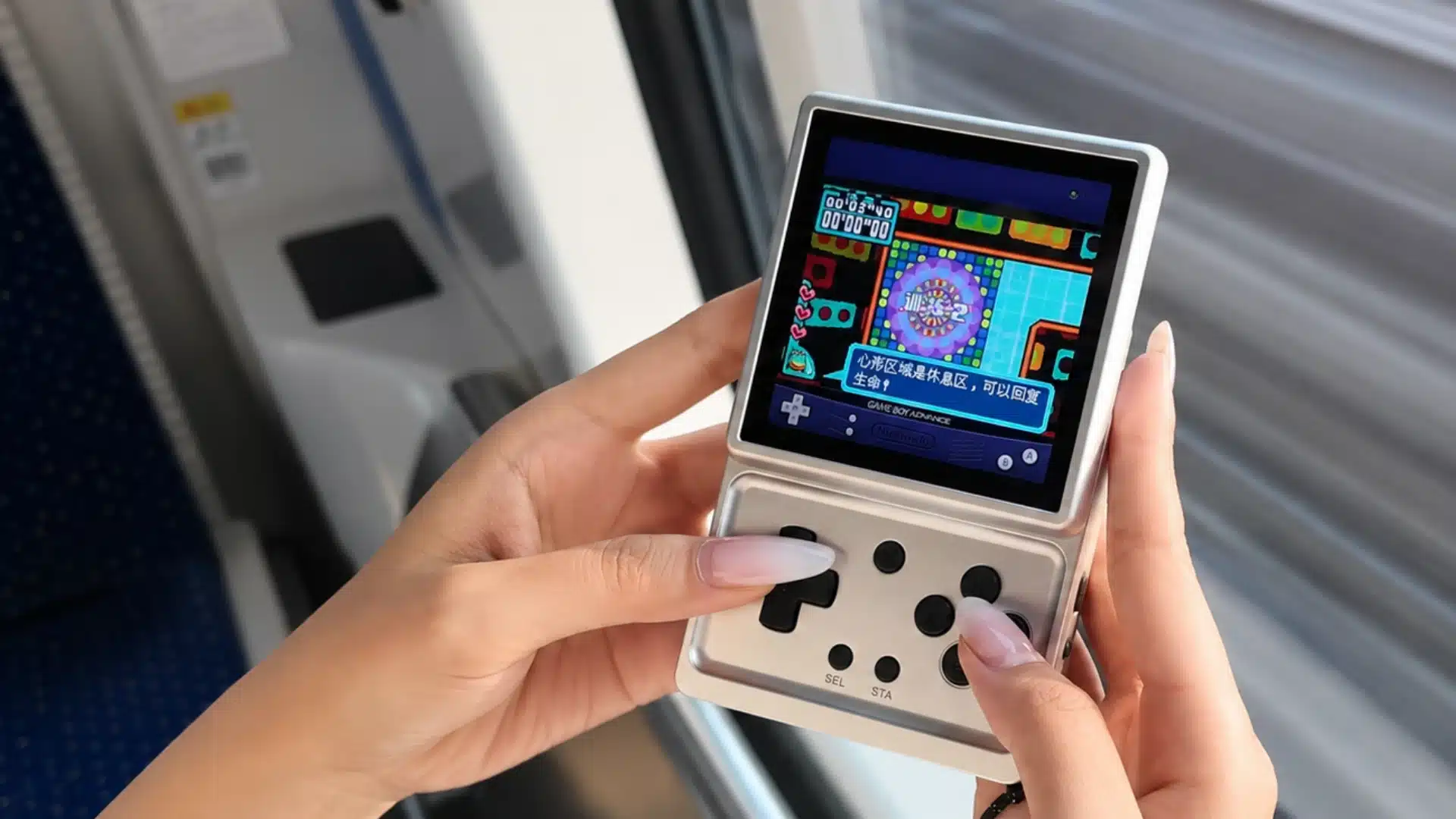 Player uses a compact retro handheld emulator while gaming during a train ride
