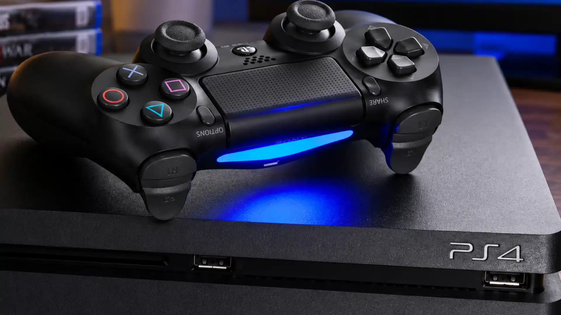 Black ps4 controller resting on console with blue light glowing across the surface