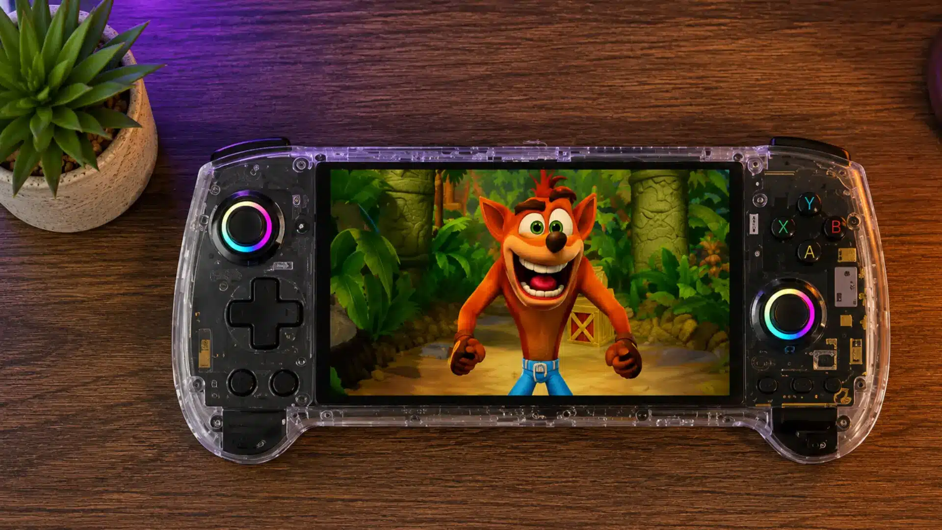 Transparent handheld console with RGB joysticks displays a colorful platform game