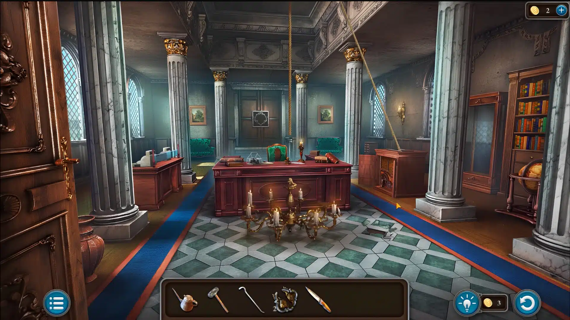 An ornate study room with marble columns, a large wooden desk, and a fallen chandelier.