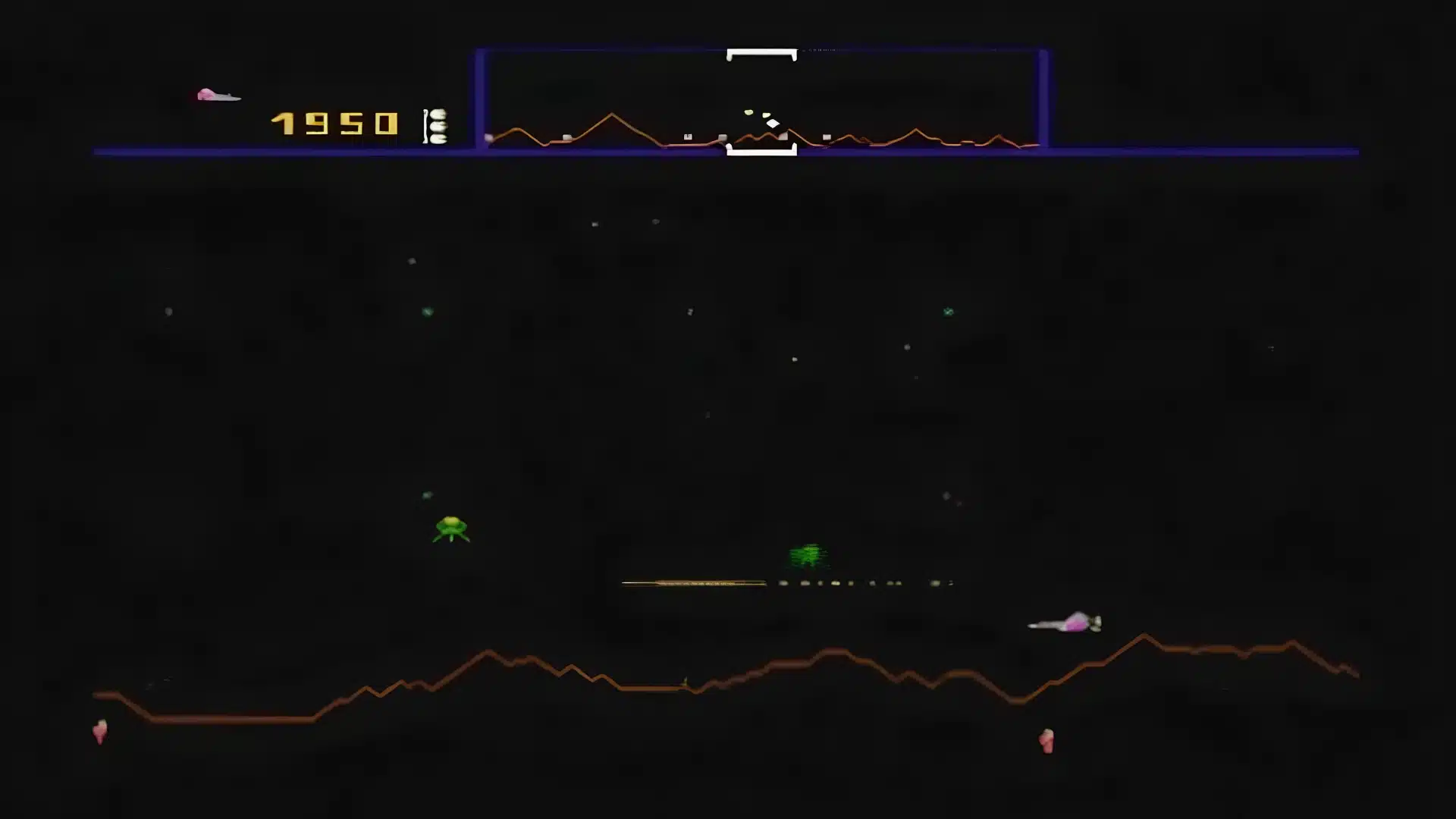 defender arcade gameplay showing spaceship combat across a scrolling landscape with enemy threats